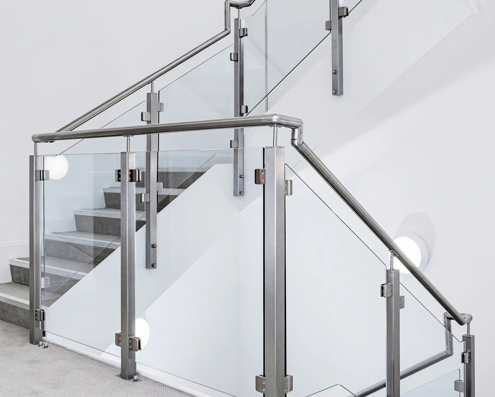 Glass staircase with stainless-steel handrails